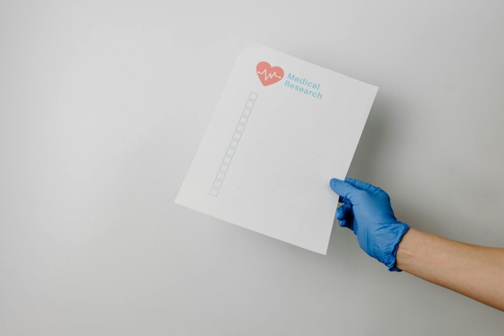 A gloved hand holding a paper titled 'Medical Research' with checkboxes.